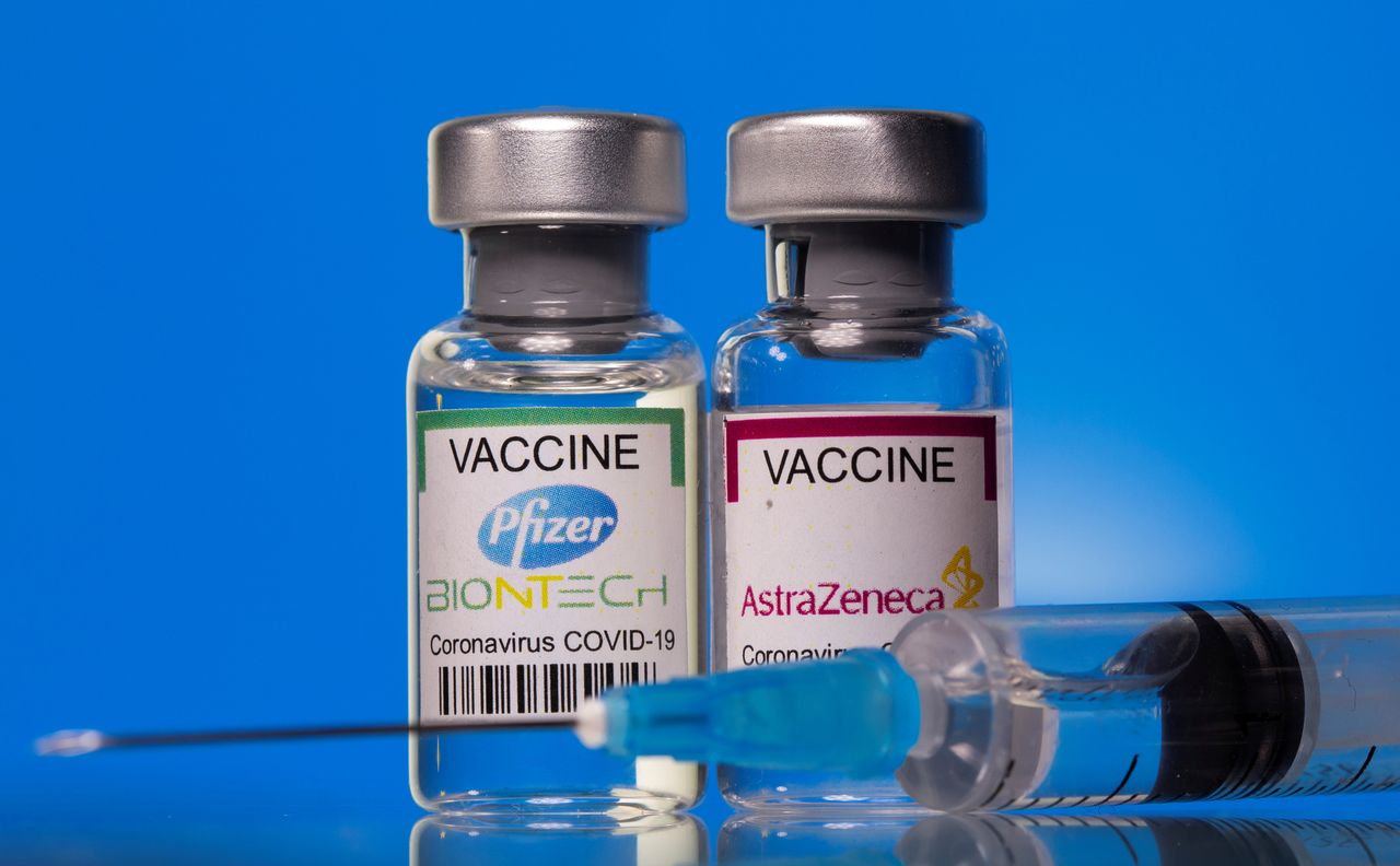 FILE PHOTO: Vials with Pfizer-BioNTech and AstraZeneca COVID-19 vaccine labels are seen in this illustration picture taken March 19, 2021. REUTERS/Dado Ruvic/Illustration