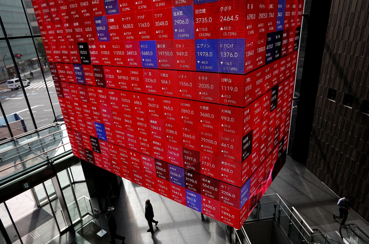 FILE PHOTO: An electronic stock quotation board is displayed inside a conference hall in Tokyo, Japan November 1, 2021. REUTERS/Issei Kato