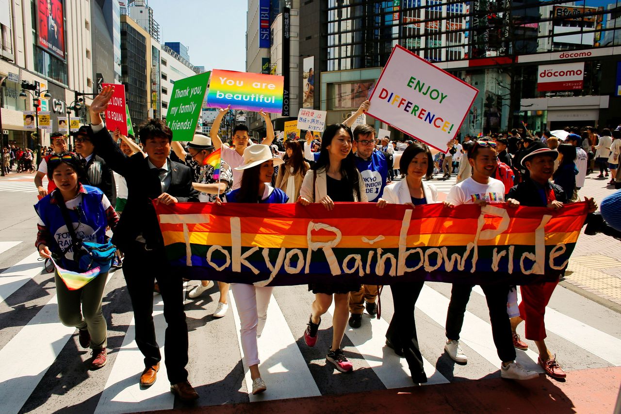 FILE PHOTO : Participants hold a banner as they march during the Tokyo Rainbow Pride parade in Tokyo April 26, 2015. REUTERS/Thomas Peter