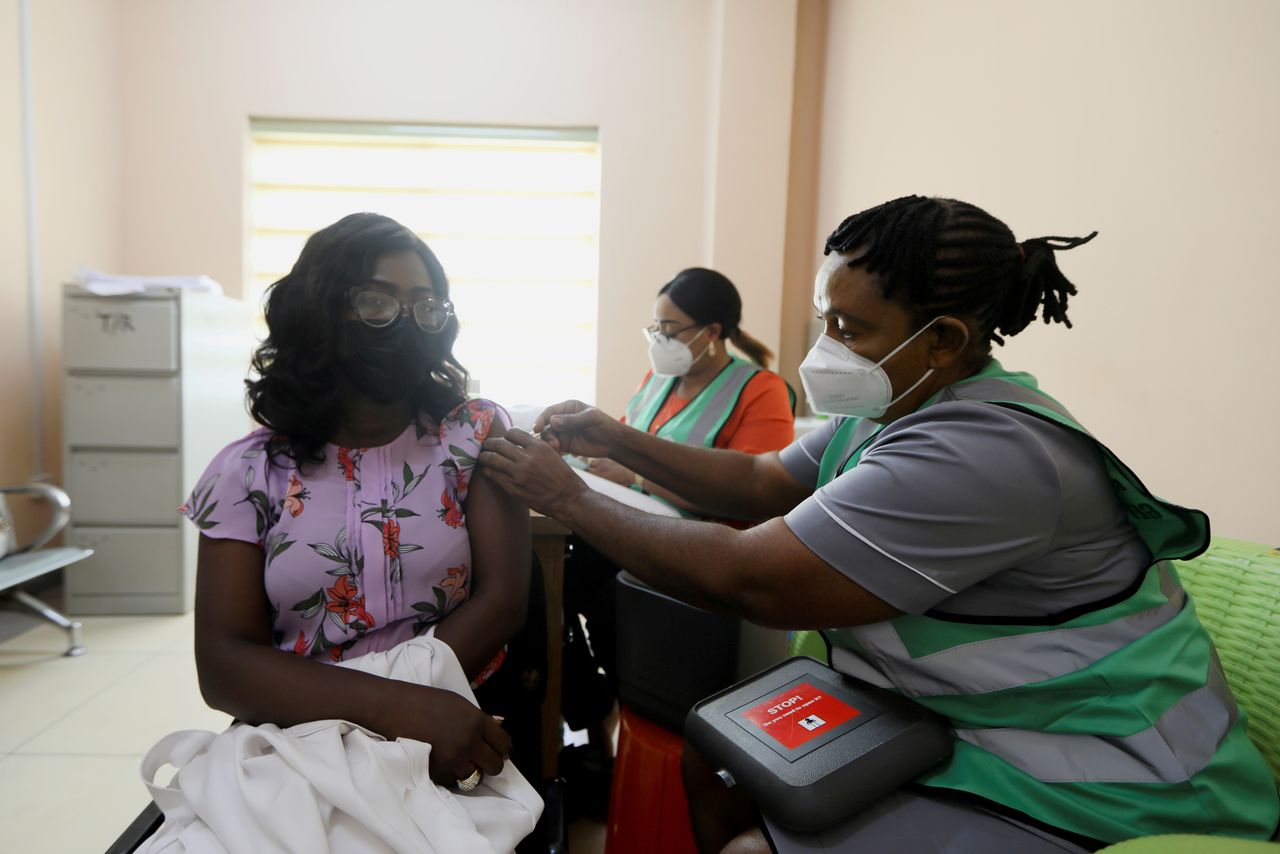 FILE PHOTO: A person receives a dose of the Oxford/AstraZeneca coronavirus vaccine at the National hospital in Abuja, Nigeria, March 5, 2021. REUTERS/Afolabi Sotunde