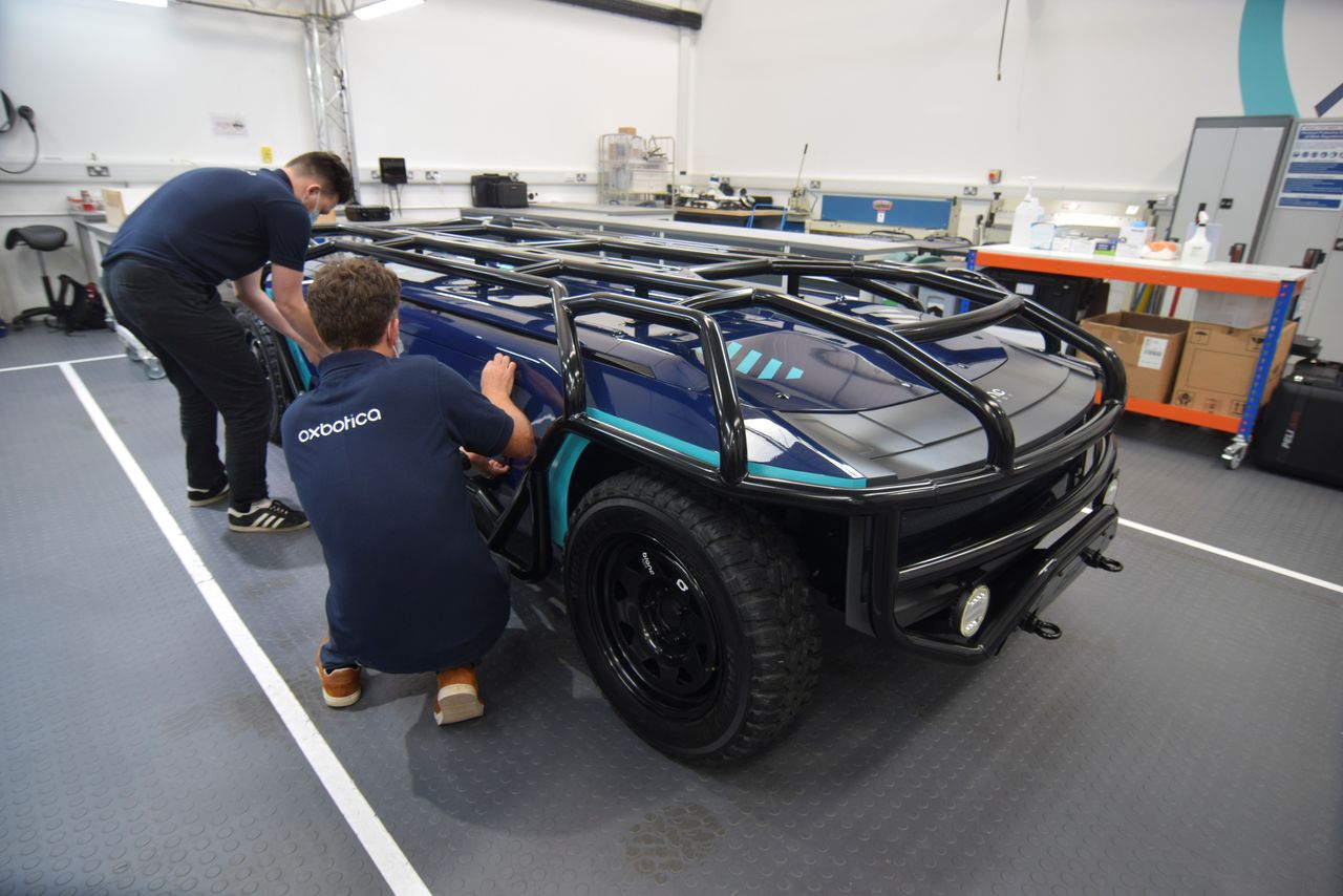 Staff at British autonomous vehicle software startup Oxbotica work on a purpose-built, fully-electric self-driving vehicle designed by Australian firm Applied EV in Oxford, Britain, October 22, 2021. REUTERS/Nick Carey