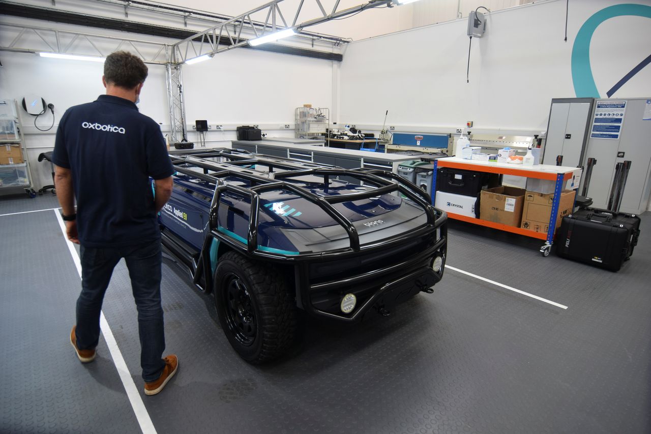 An employee at British autonomous vehicle software startup Oxbotica works on a purpose-built, fully-electric self-driving vehicle designed by Australian firm Applied EV in Oxford, Britain, October 22, 2021. REUTERS/Nick Carey