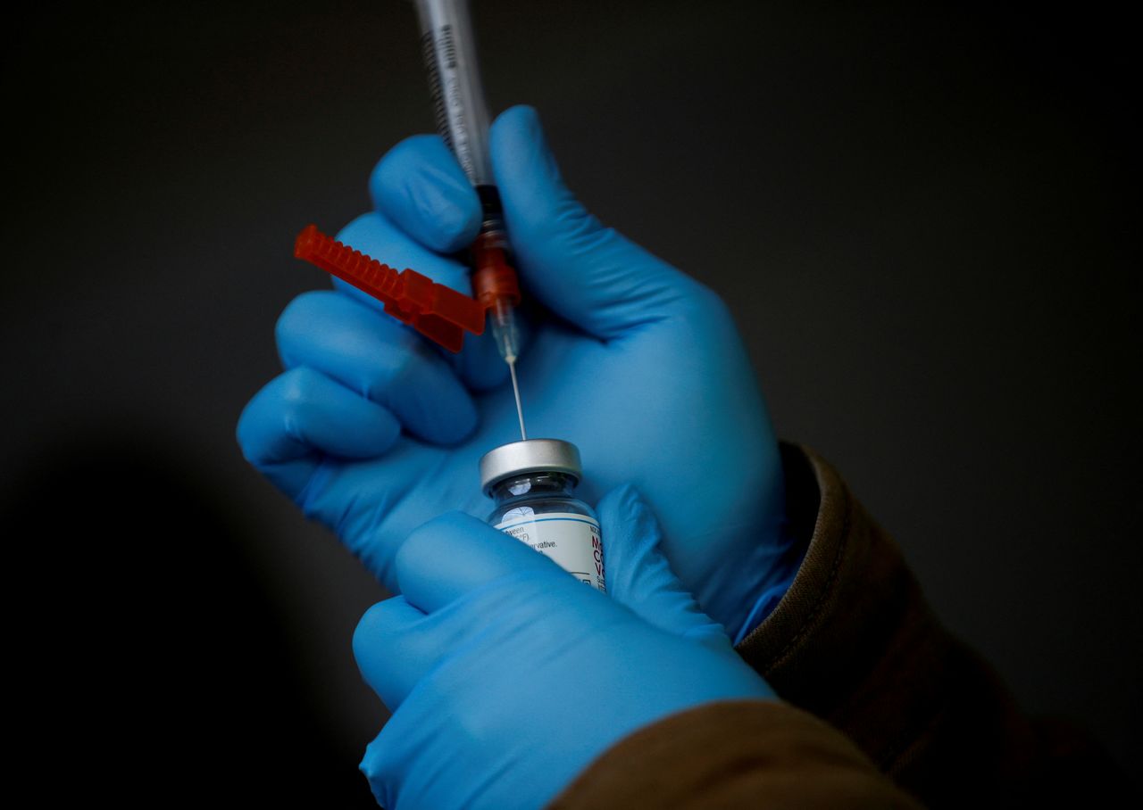 FILE PHOTO: A healthcare worker draws a dose of the Moderna COVID-19 vaccine from a vial at a free drive-through coronavirus disease (COVID-19) vaccine clinic for people 70 and older and their spouse or partner, run by the Jamestown S