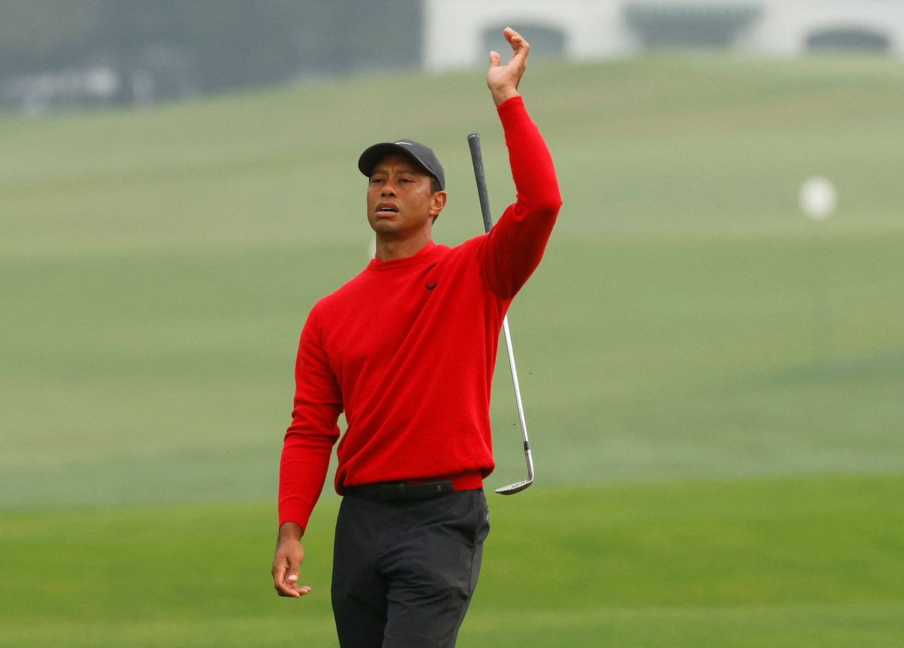 FILE PHOTO: Golf - The Masters - Augusta National Golf Club - Augusta, Georgia, U.S. - November 15, 2020 Tiger Woods of the U.S. reacts after chipping onto the 2nd green during the final round REUTERS/Brian Snyder