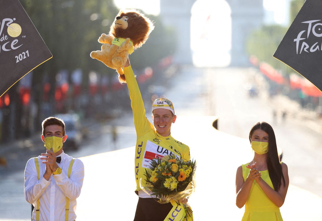 FILE PHOTO: Cycling - Tour de France - Stage 21 - Chatou to Paris Champs-Elysees - France - July 18, 2021 UAE Team Emirates rider Tadej Pogacar of Slovenia celebrates on the podium after winning the yellow jersey and the Tour de France Pool  via REUTERS/Garnier Etienne