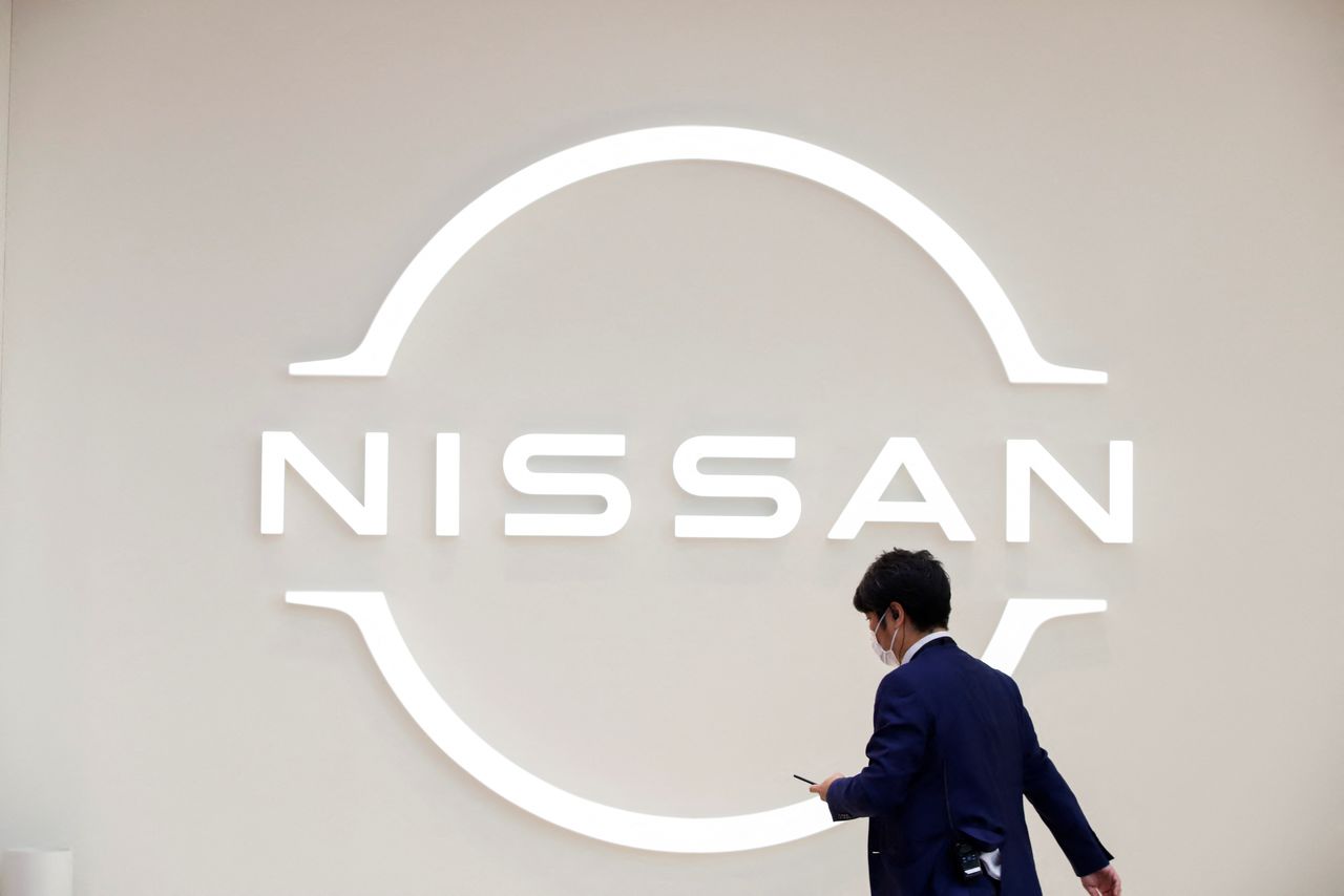 A man walks in front of the Nissan logo at Nissan Gallery in Yokohama, Japan November 29, 2021. REUTERS/Androniki Christodoulou