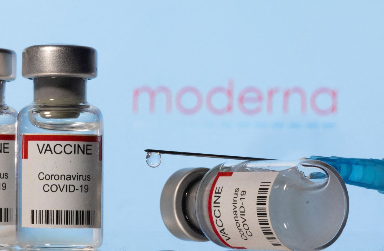 FILE PHOTO: Vials labelled "VACCINE Coronavirus COVID-19" and a syringe are seen in front of a displayed Moderna logo in this illustration taken December 11, 2021. REUTERS/Dado Ruvic/Illustration