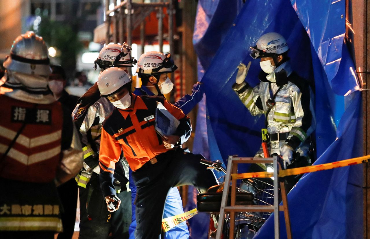Firefighters work outside a building where a fire broke out in Osaka, Japan December 17, 2021. REUTERS/Kim Kyung-Hoon
