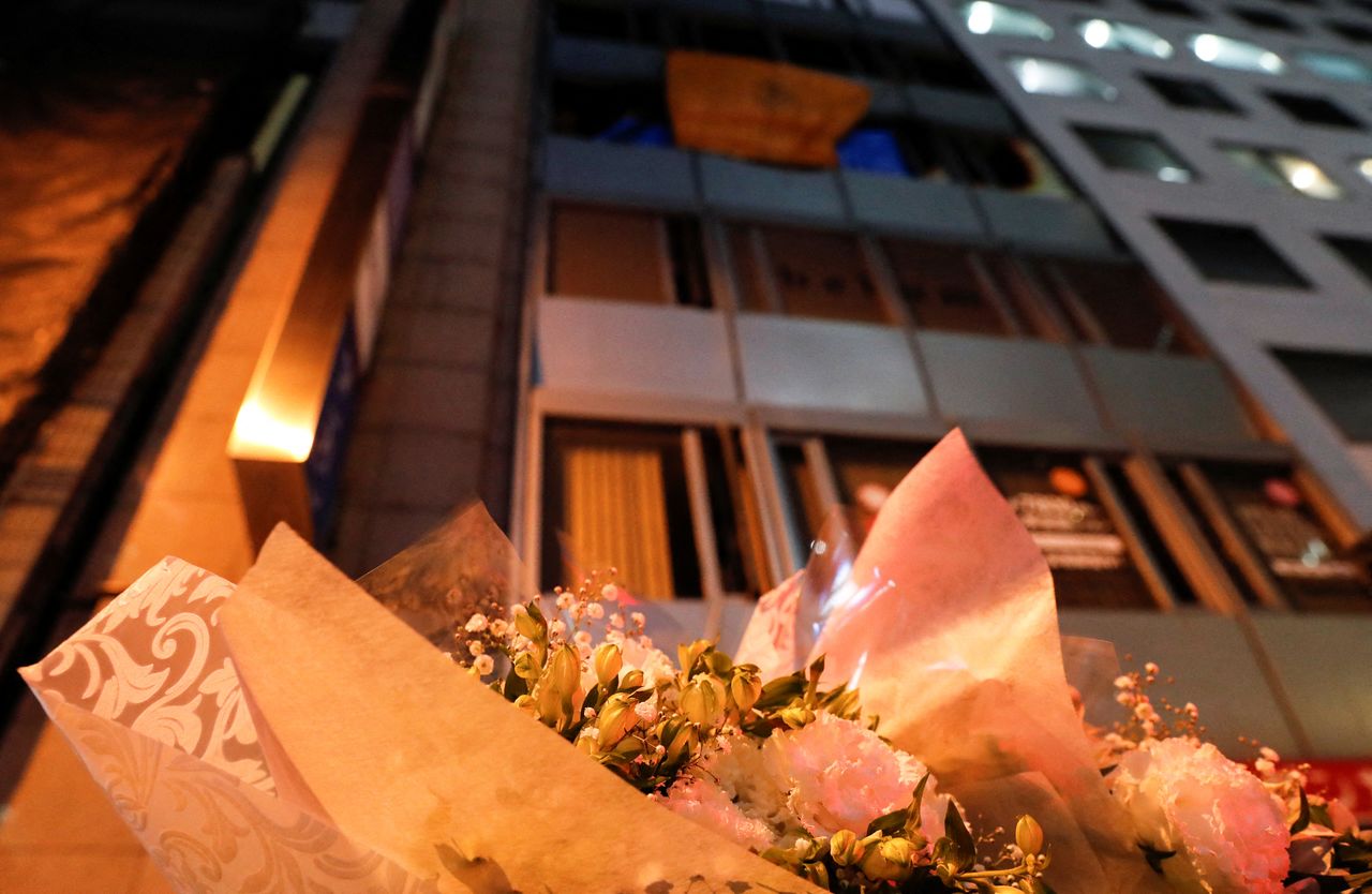 Flowers are laid down for victims in front of a building where a fire broke out in Osaka, Japan December 17, 2021. REUTERS/Kim Kyung-Hoon