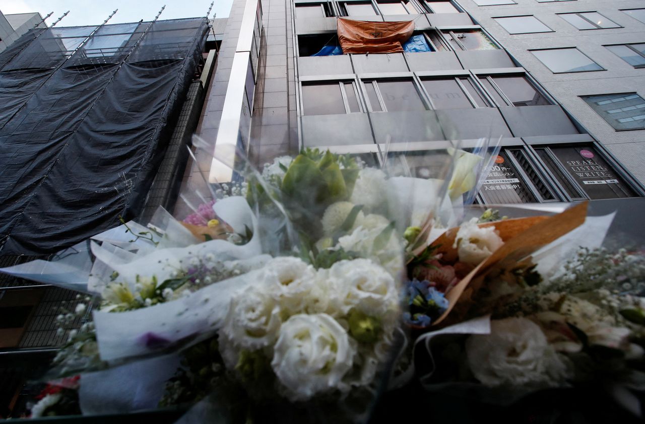 Flowers are placed by the building where a fire broke out, in Osaka, Japan December 18, 2021. REUTERS/Kim Kyung-Hoon