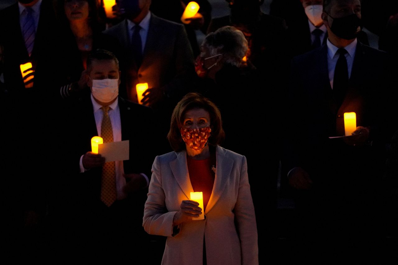 Bipartisan members of the House and Senate, including House Speaker Nancy Pelosi (D-CA), gather to hold a moment of silence for the more than 800,000 American lives lost to COVID-19 outside the U.S. Capitol building in Washington, U.S., December 14, 2021. REUTERS/Elizabeth Frantz