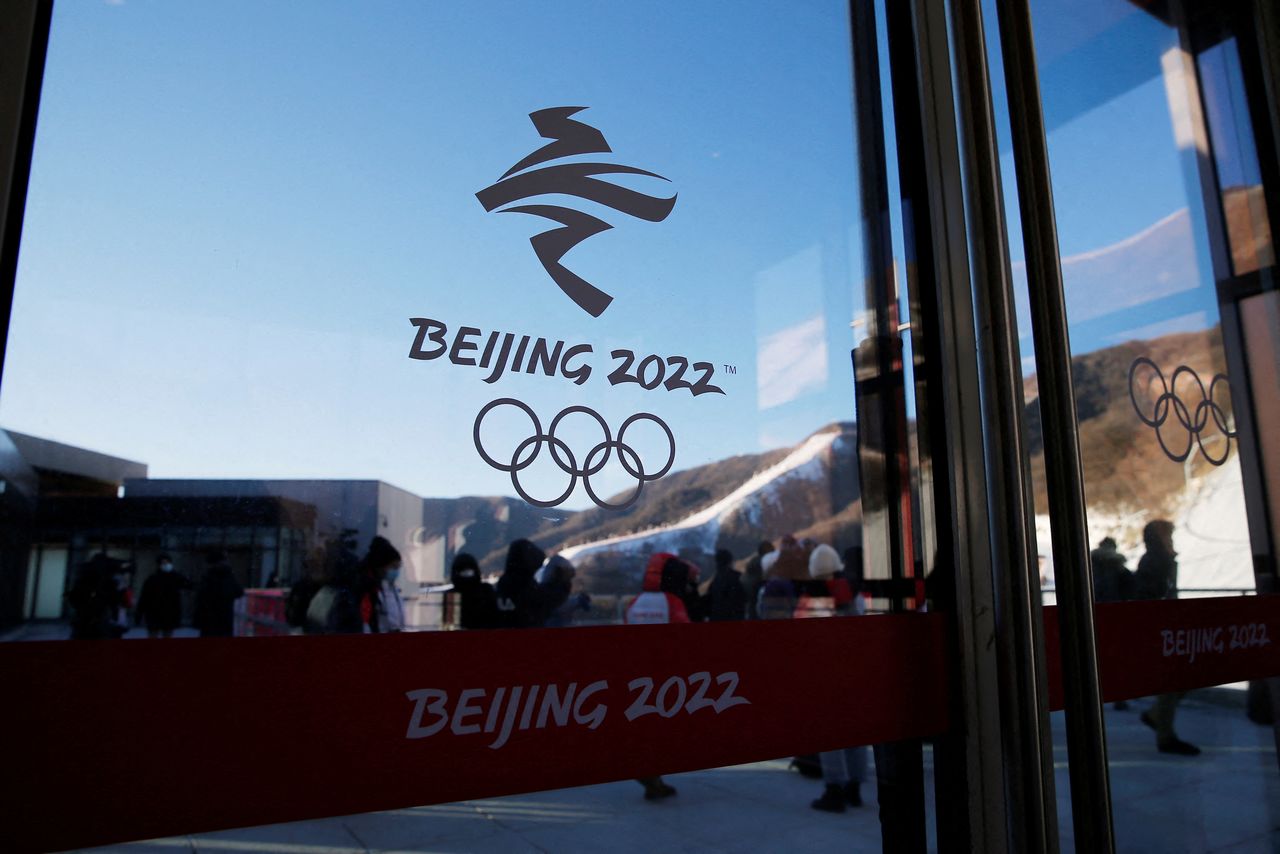 The emblem of Beijing 2022 Winter Olympics is seen on a glass door at the National Alpine Skiing Centre during an organised media tour to the Olympic venues in Yanqing district of Beijing, China December 17, 2021. REUTERS/Tingshu Wang