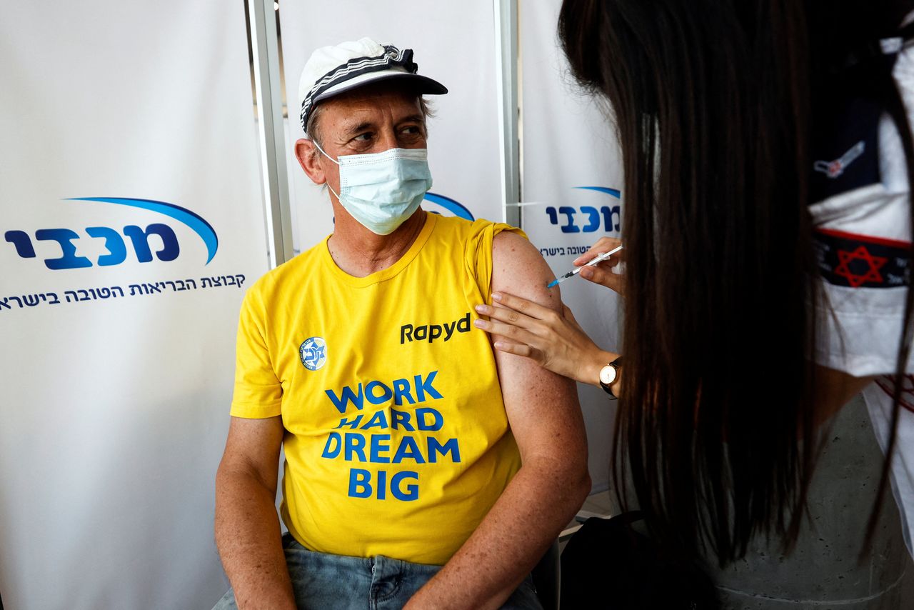 FILE PHOTO: An Israeli man receives a third shot of coronavirus disease (COVID-19) vaccine in Tel Aviv, Israel August 30, 2021. REUTERS/Amir Cohen