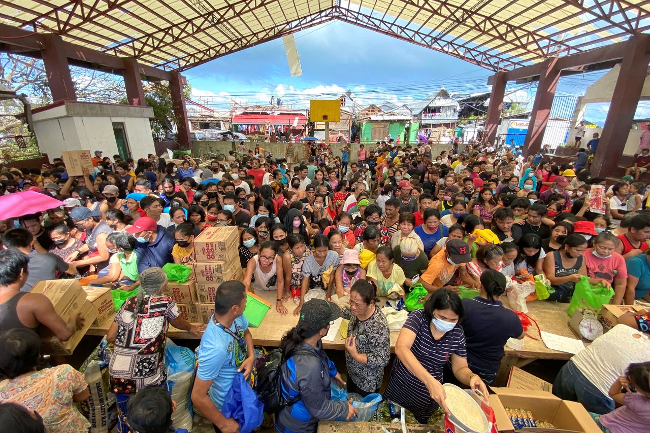 People affected by the typhoon Rai gather during a distribution of relief goods, in Surigao City, Surigao del Norte, Philippines, December 20, 2021. Picture taken December 20, 2021. Erwin Mascarinas/Greenpeace/Handout via REUTERS