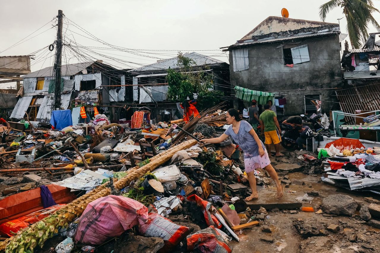 A woman tends to her damaged properties following typhoon Rai, in Surigao City, Surigao del Norte, Philippines, December 19, 2021. Picture taken December 19, 2021. Jilson Tiu/Greenpeace/Handout via REUTERS THIS IMAGE HAS BEEN SUPPLIED BY A THIRD PARTY. NO RESALE. NO ARCHIVE. MANDATORY CREDIT