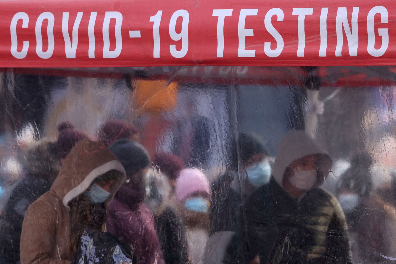 People queue to be tested for COVID-19 in Times Square, as the Omicron coronavirus variant continues to spread in Manhattan, New York City, U.S., December 20, 2021. REUTERS/Andrew Kelly