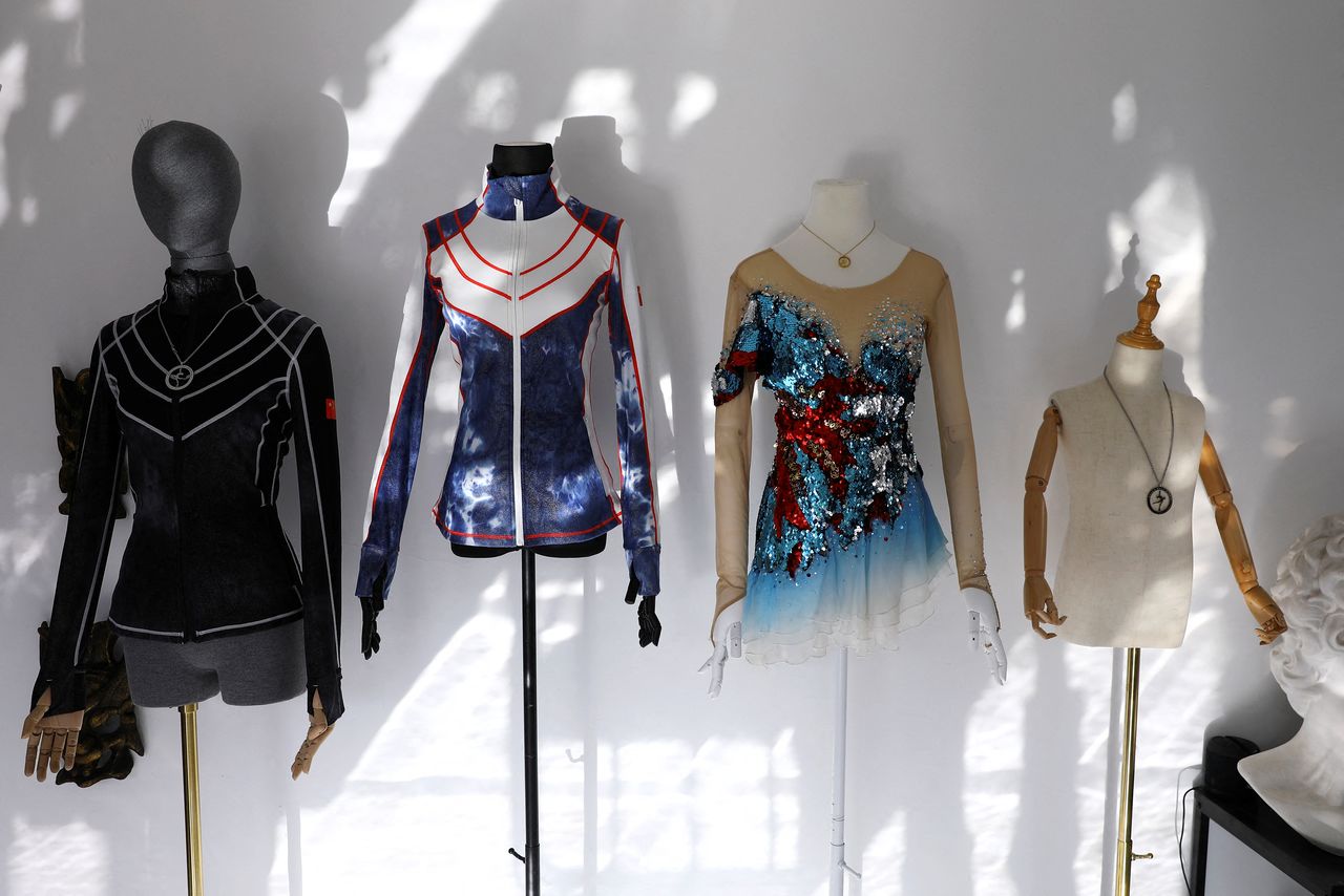 Skating jackets for training and a skating dress, which are all designed by costume designer Zhang Yifan, are displayed at her studio in Beijing, China December 7, 2021.REUTERS/Tingshu Wang