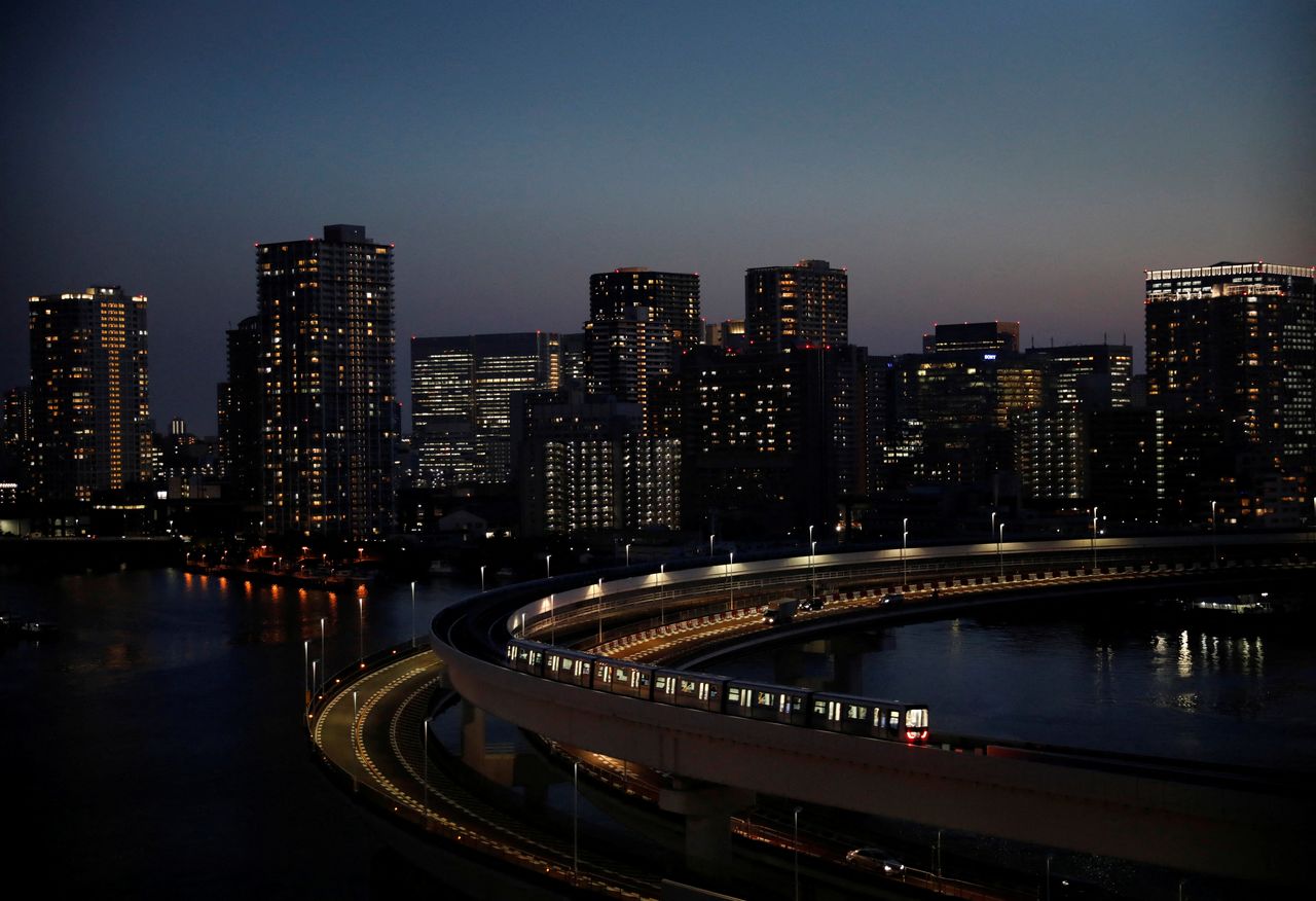 FILE PHOTO: A train of the Yurikamome line, a driverless automatic train system, runs with the city skyline in the background, in Tokyo, Japan, April 21, 2021. Picture taken April 21, 2021.  REUTERS/Kim Kyung-Hoon