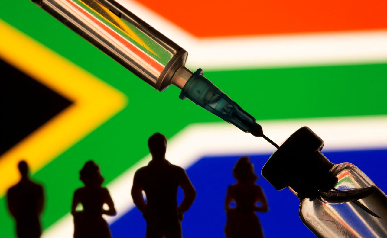 FILE PHOTO: A vial, syringe, and small toy figures are seen in front of displayed South Africa flag in this illustration taken, February 9, 2021. REUTERS/Dado Ruvic