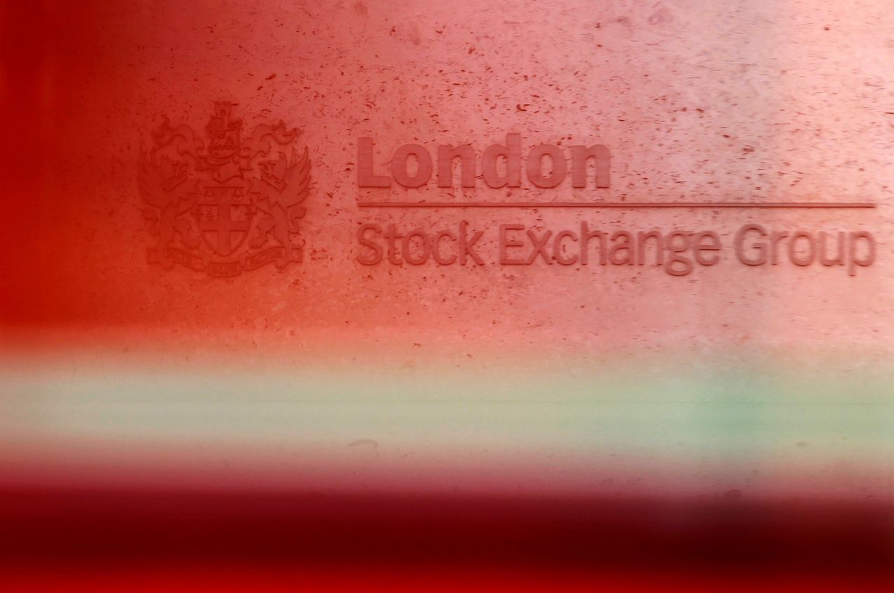 FILE PHOTO: A red London bus passes the Stock Exchange in London, Britain, February 9, 2011.   REUTERS/Luke MacGregor/File Photo