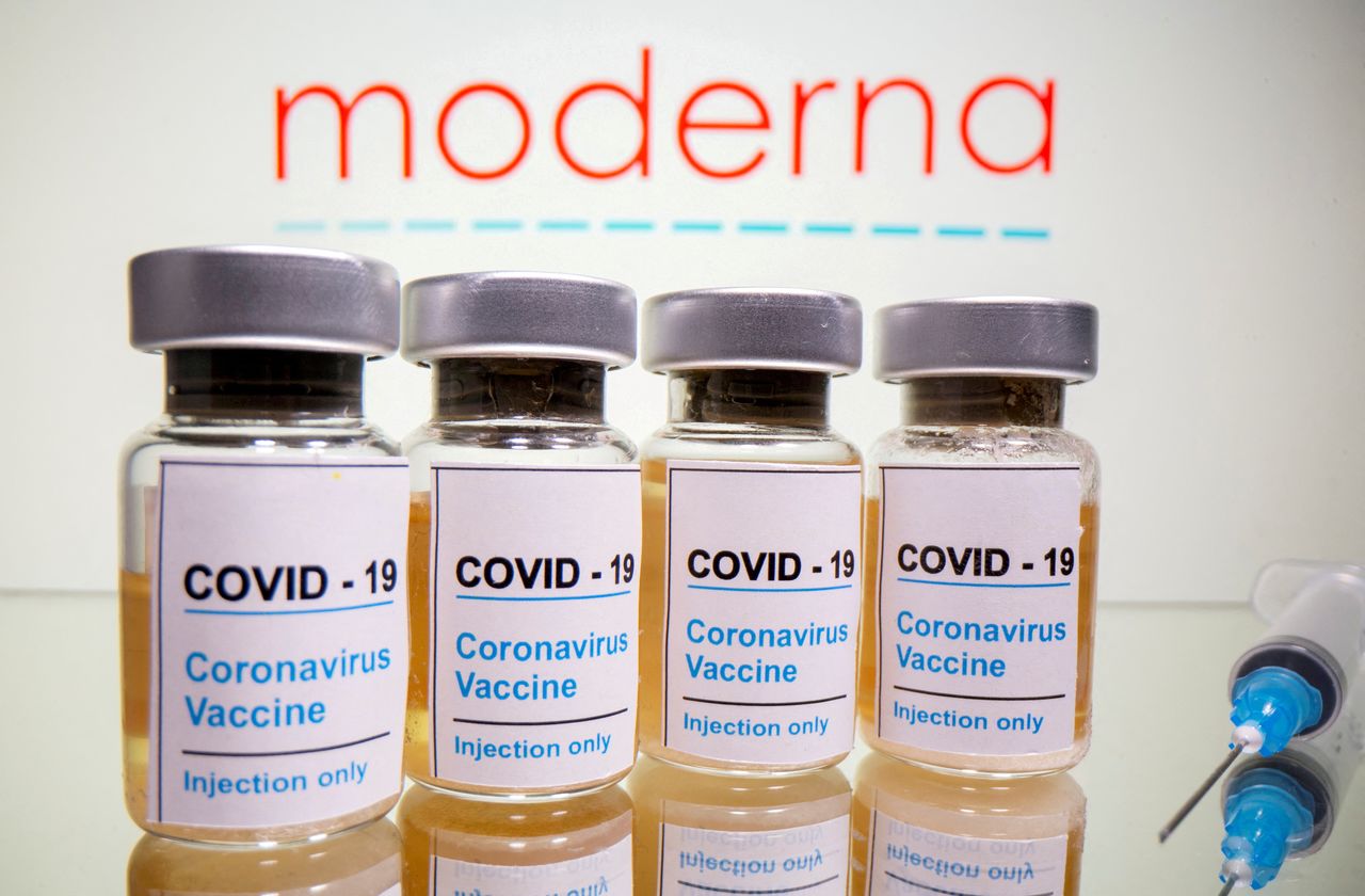 FILE PHOTO: Vials with a sticker reading, "COVID-19 / Coronavirus vaccine / Injection only" and a medical syringe are seen in front of a displayed Moderna logo in this illustration taken October 31, 2020. REUTERS/Dado Ruvic