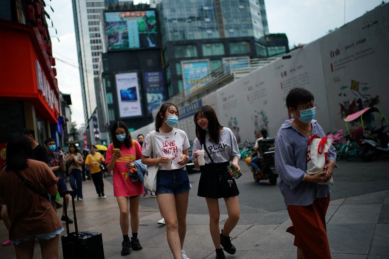 FILE PHOTO: People wearing face masks walk at a shopping area following the coronavirus disease (COVID-19) outbreak, in Chengdu, Sichuan province, China September 8, 2020. REUTERS/Tingshu Wang