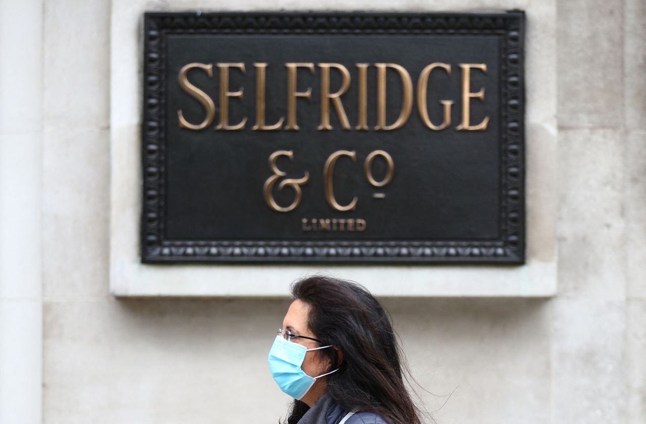A woman wearing a protective mask walks past a Selfridges store at Oxford Street, amid the coronavirus disease (COVID-19) outbreak, in London, Britain July 28, 2020. REUTERS/Hannah McKay