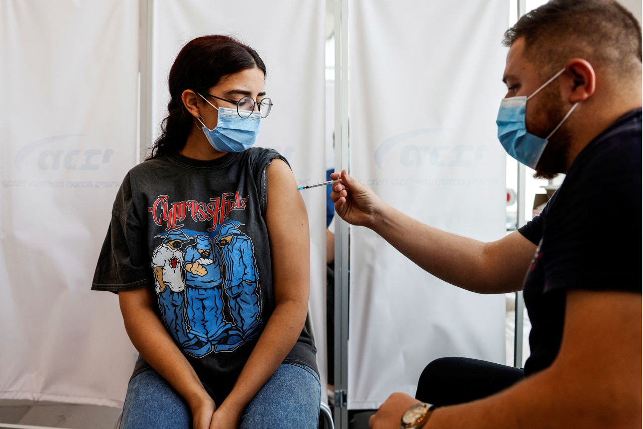 FILE PHOTO: An Israeli woman receives a third shot of coronavirus disease (COVID-19) vaccine in Tel Aviv, Israel August 30, 2021. REUTERS/Amir Cohen