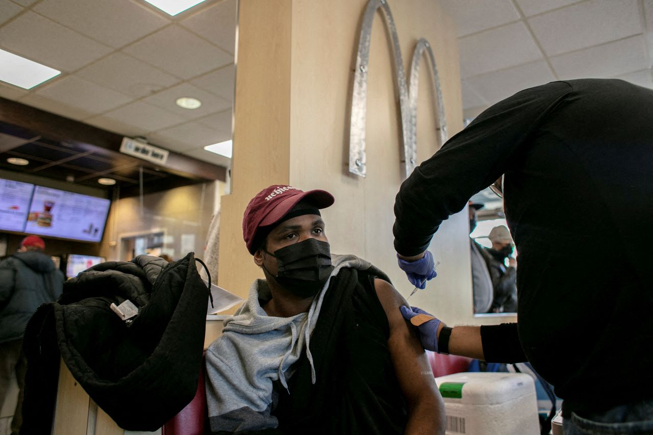 FILE PHOTO: A man receives a booster shot for the coronavirus disease (COVID-19) at a McDonald