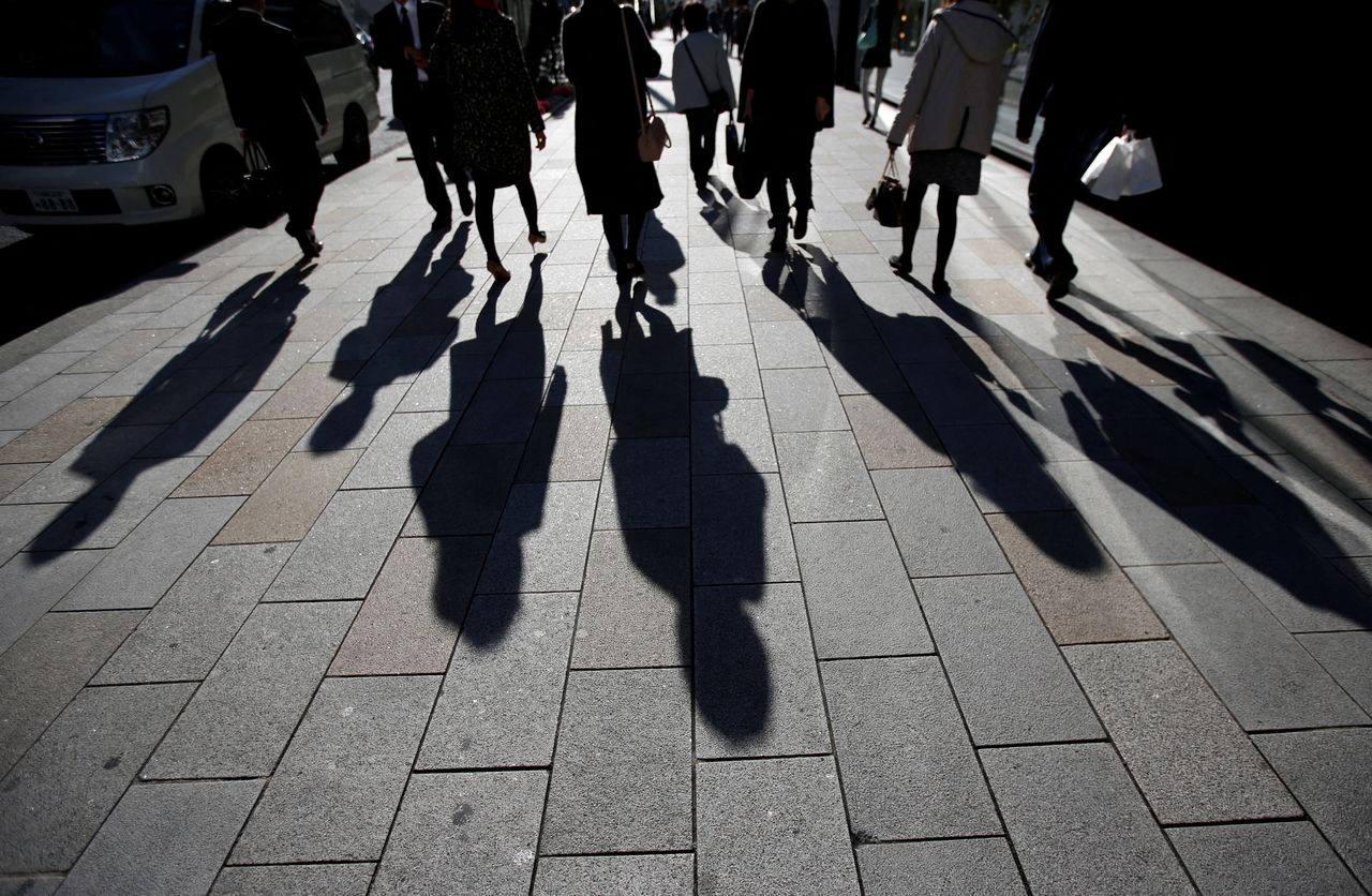 FILE PHOTO: The shadows of pedestrians are pictured cast on a street in Tokyo, Japan, November 27, 2014.  REUTERS/Issei Kato