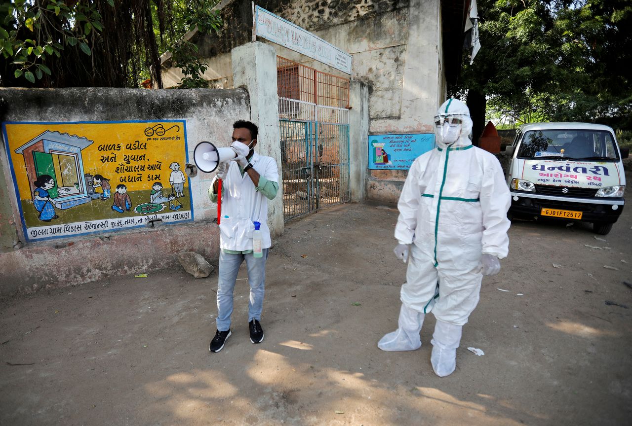 FILE PHOTO: A healthcare worker announces to people to get their rapid antigen tests done during a door-to-door survey for the coronavirus disease (COVID-19), in Jakhan village in the western state of Gujarat, India, September 22, 2020. REUTERS/Amit Dave