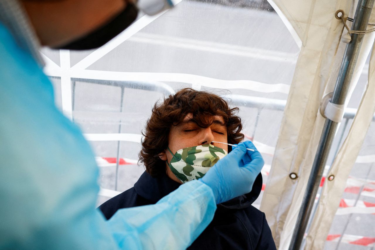 A man takes a coronavirus disease (COVID-19) test at a pharmacy as COVID-19 infections rise, in Rome, Italy, December 29, 2021. REUTERS/Guglielmo Mangiapane