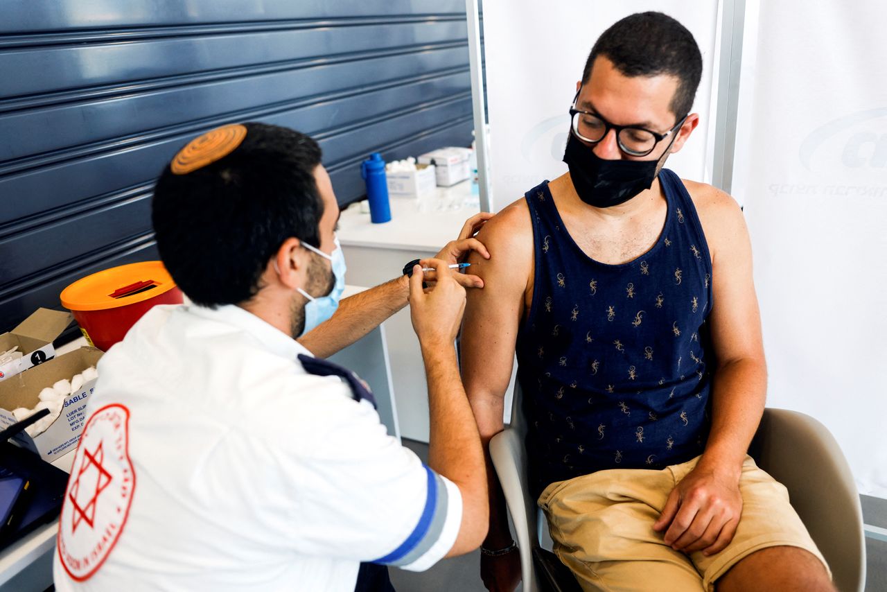 FILE PHOTO: An Israeli man receives a third shot of coronavirus disease (COVID-19) vaccine in Tel Aviv, Israel August 30, 2021. REUTERS/Amir Cohen