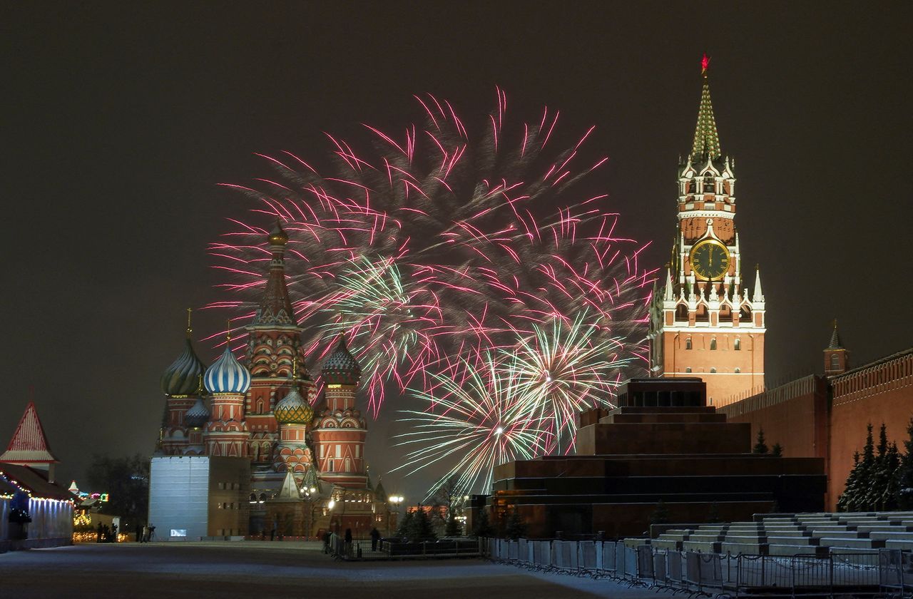 Fireworks explode in the sky over the Kremlin and St. Basil’s cathedral during the New Year