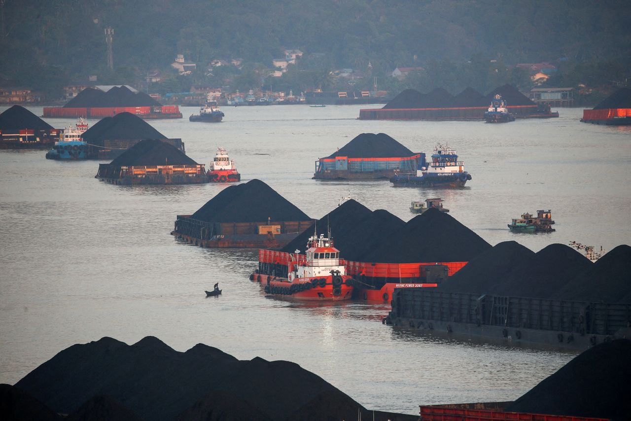 FILE PHOTO: Coal barges are pictured as they queue to be pulled along Mahakam river in Samarinda, East Kalimantan province, Indonesia, August 31, 2019. REUTERS/Willy Kurniawan