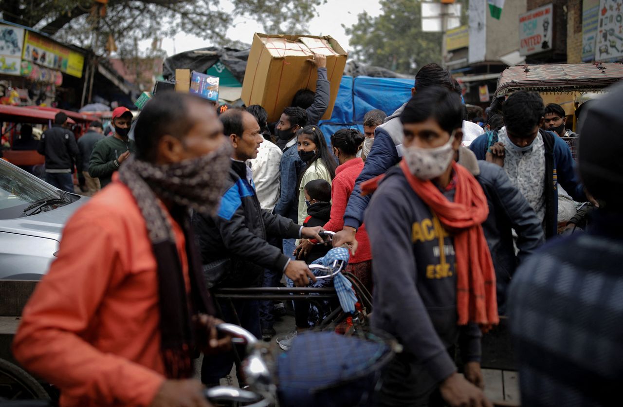 People walk at a crowded market amidst the spread of the coronavirus disease (COVID-19), in the old quarters of Delhi, India, January 4, 2022. REUTERS/Adnan Abidi