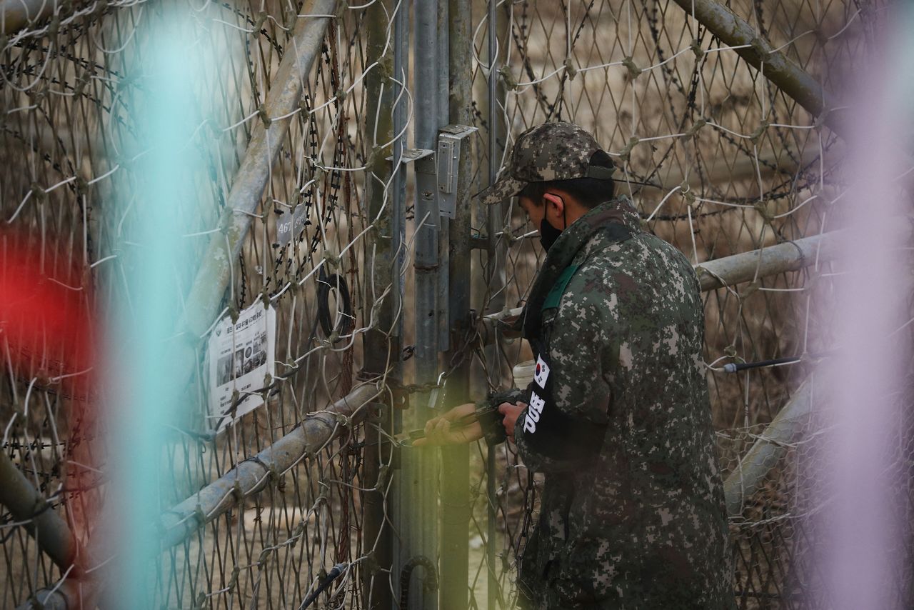 A South Korean soldier locks an entrance to a guard post near the demilitarised zone which separates the two Koreas in Paju, South Korea, January 5, 2022. REUTERS/Kim Hong-Ji