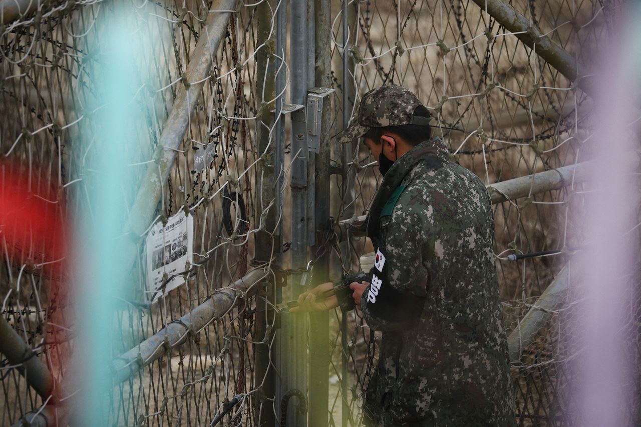 A South Korean soldier locks an entrance to a guard post near the demilitarised zone which separates the two Koreas in Paju, South Korea, January 5, 2022. REUTERS/Kim Hong-Ji