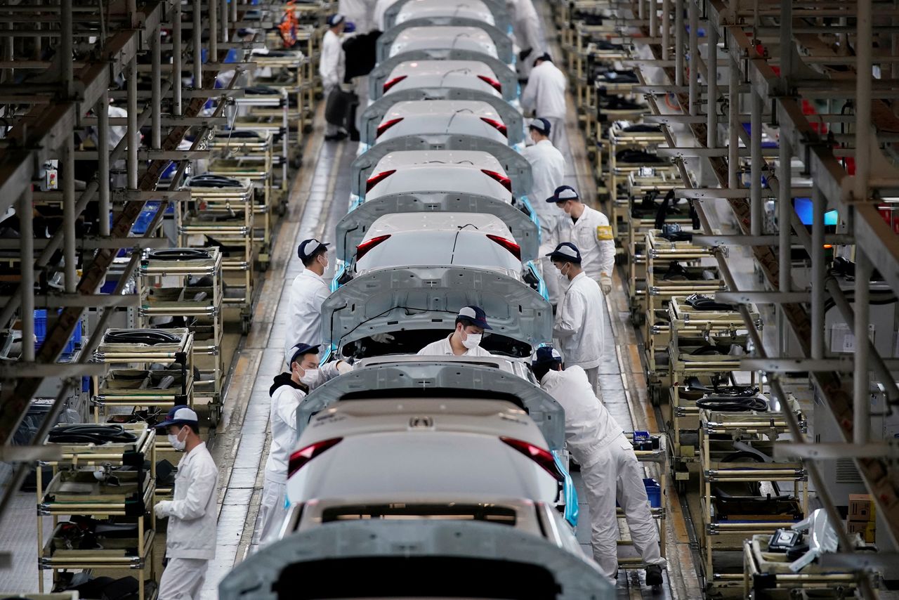FILE PHOTO: Employees work on a production line inside a Dongfeng Honda factory after lockdown measures in Wuhan, the capital of Hubei province and China