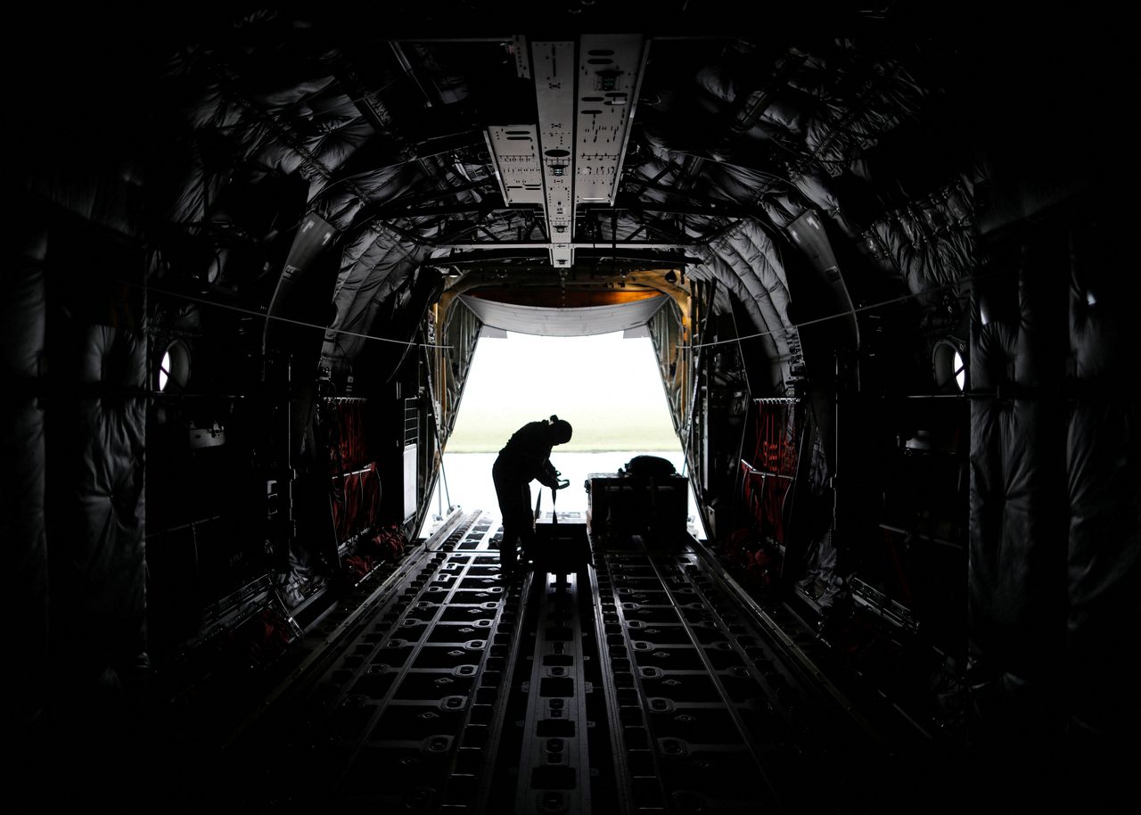 FILE PHOTO: A U.S. soldier wearing a protective face mask is seen inside a C-130 transport plane during a military drill amid the coronavirus disease (COVID-19) outbreak, at Yokota U.S. Air Force Base in Fussa, on the outskirts of Tokyo, Japan May 21, 2020.  REUTERS/Issei Kato