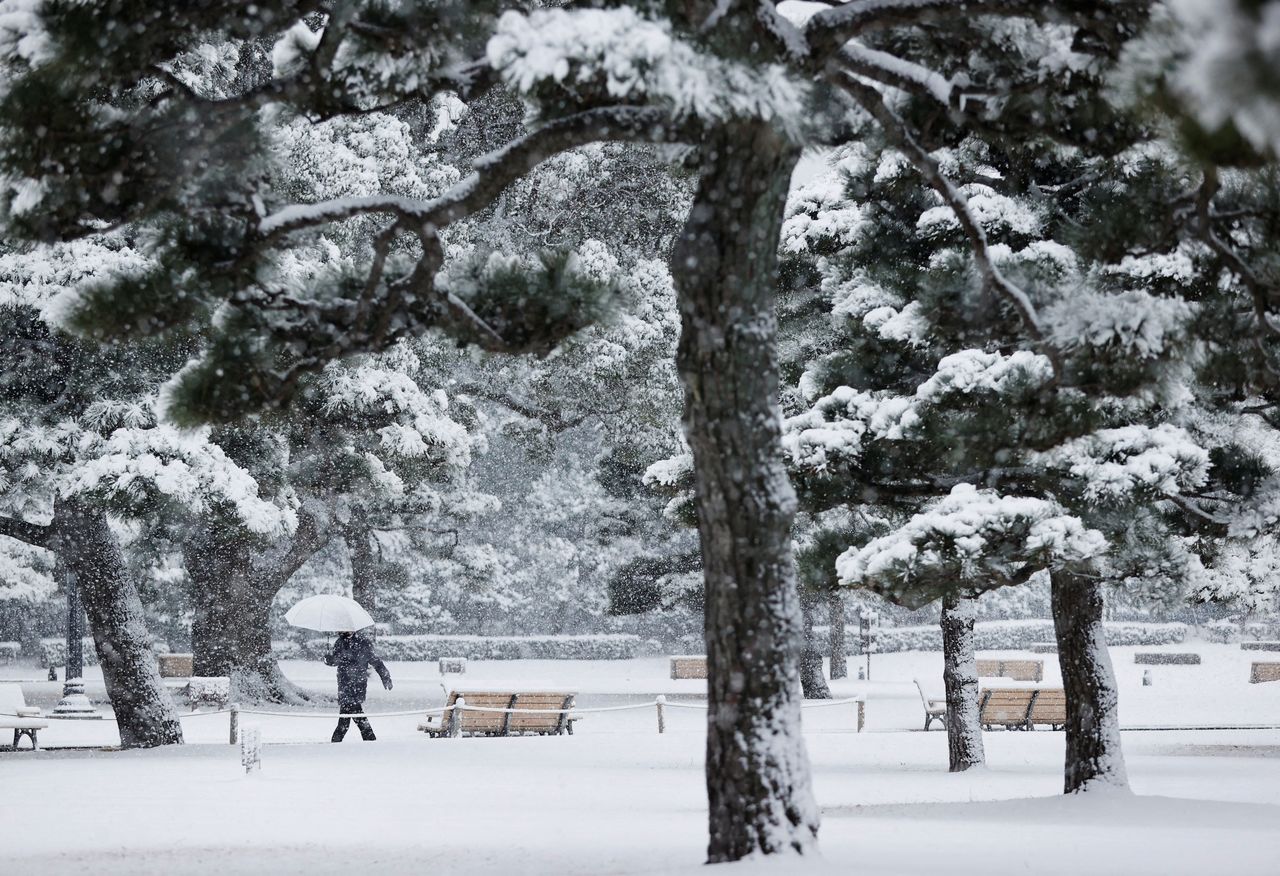 A man walks at the snow-covered Imperial Palace, amid the coronavirus disease (COVID-19) pandemic, in Tokyo, Japan January 6, 2022. REUTERS/Issei Kato