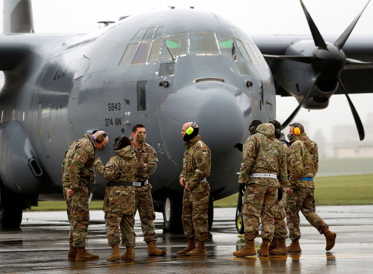 FILE PHOTO: U.S. soldiers wearing protective face masks are seen in front of C-130 transport plane during a military drill amid the coronavirus disease (COVID-19) outbreak, at Yokota U.S. Air Force Base in Fussa, on the outskirts of Tokyo, Japan May 21, 2020. REUTERS/Issei Kato