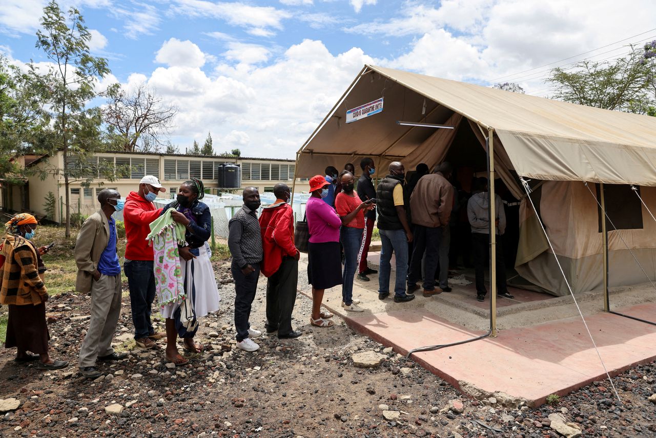 FILE PHOTO: People stand in line to receive a COVID-19 vaccine, at the Narok County Referral Hospital, in Narok, Kenya, December 1, 2021. REUTERS/Baz Ratner