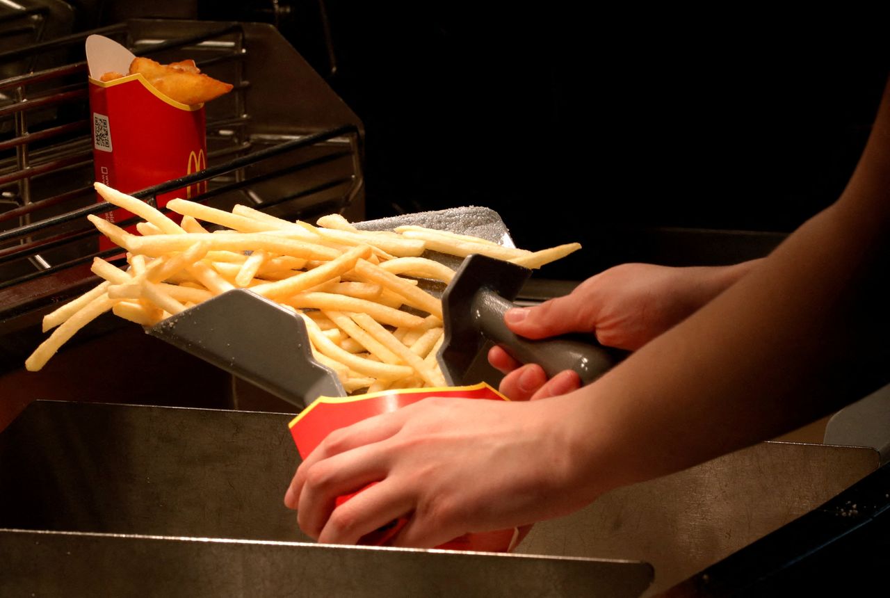 FILE PHOTO: An employee cooks French fries at a McDonald