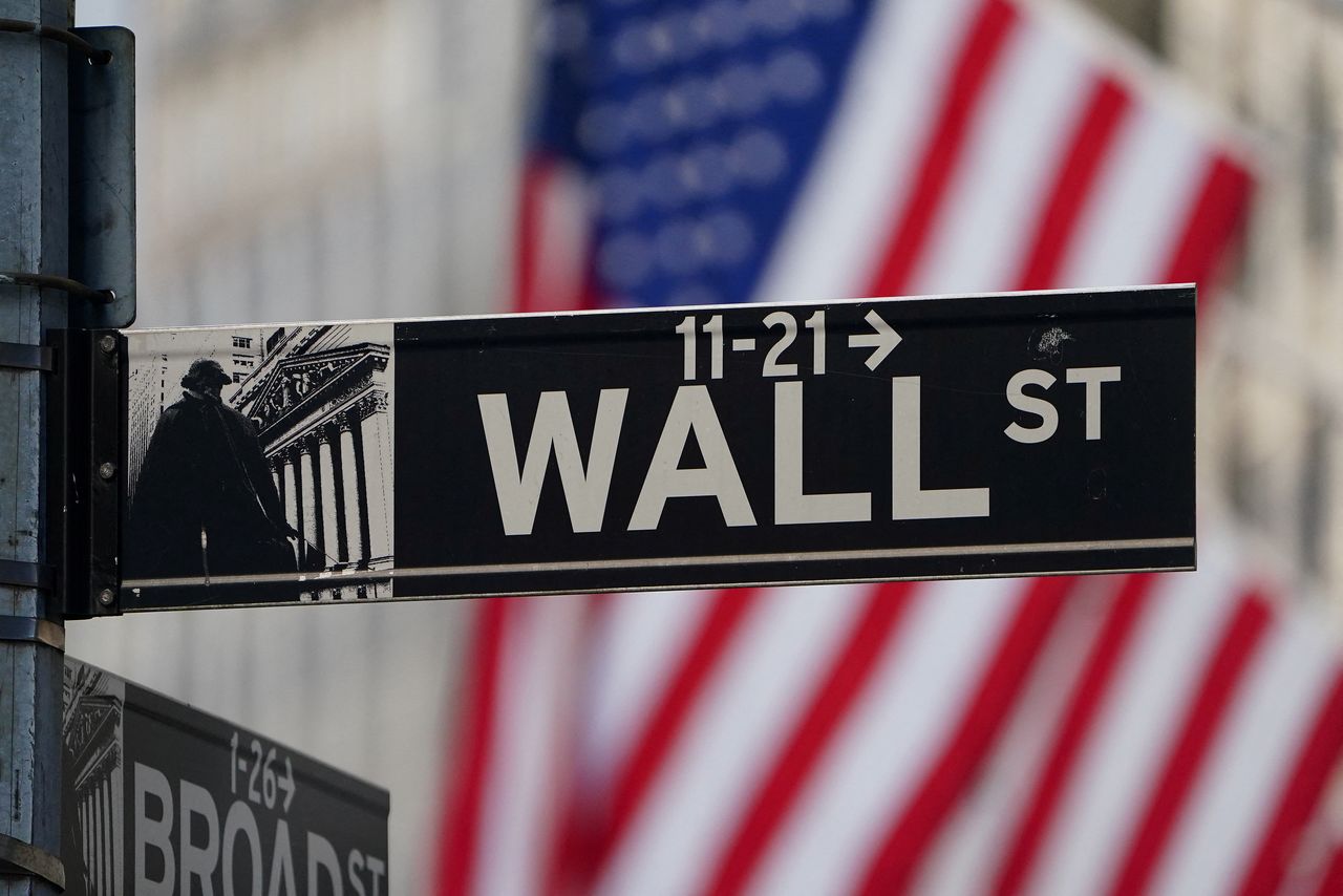 FILE PHOTO: The Wall Street sign is pictured at the New York Stock exchange (NYSE) in the Manhattan borough of New York City, New York, U.S., March 9, 2020. REUTERS/Carlo Allegri