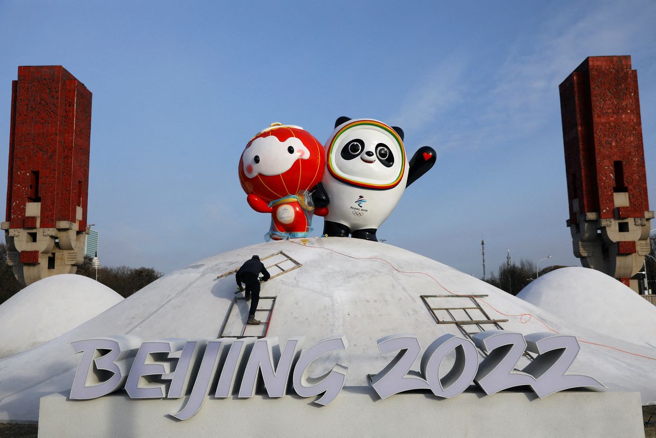 A worker sets up an installation featuring Bing Dwen Dwen, the Beijing 2022 Winter Olympic Mascot and Shuey Rhon Rhon, the 2022 Beijing Winter Paralympic Games Mascot, in Beijing, China January 11, 2022. REUTERS/Tingshu Wang
