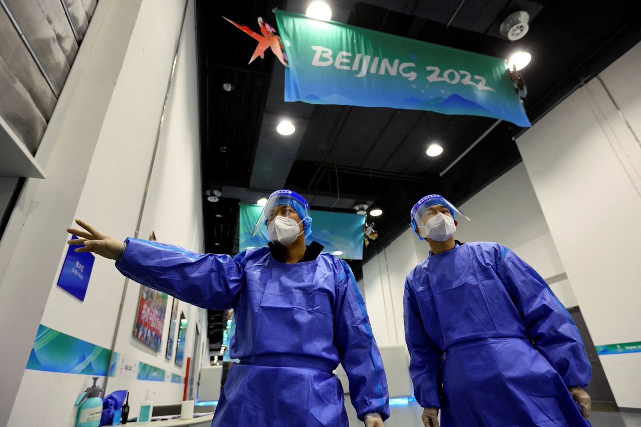 Members of a disinfection team are seen ahead of the Beijing 2022 Winter Olympics at the Main Press Centre, in Beijing, China, January 10, 2022. REUTERS/Fabrizio Bensch