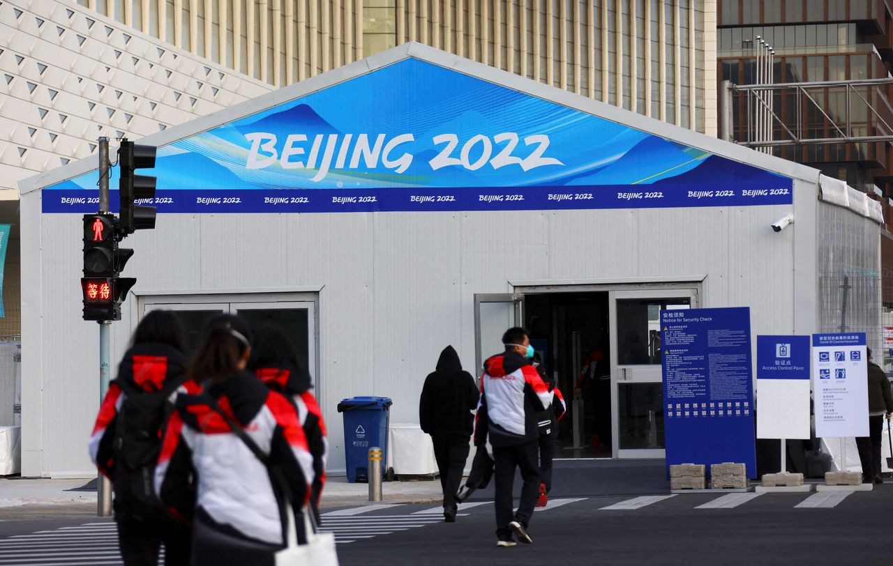 Volunteers walk outside the Main Press Centre ahead of the Beijing 2022 Winter Olympics in Beijing, China, January 11, 2022. REUTERS/Fabrizio Bensch