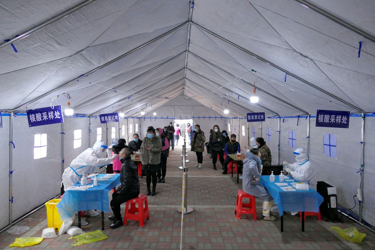 People line up for nucleic acid testing during a citywide mass testing for the coronavirus disease (COVID-19) after local cases of the Omicron variant were detected in Tianjin, China January 9, 2022. cnsphoto via REUTERS