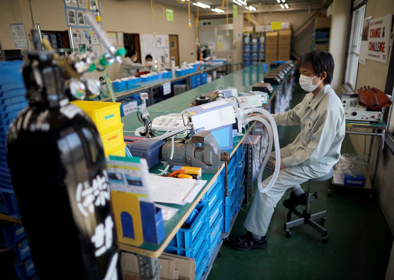 FILE PHOTO: Employees of Sanko Manufacturing Co. are seen at the assembly line of the company